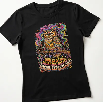 Colorful whimsical illustration of an owl with text about facial expressions — printed on a women's shirt