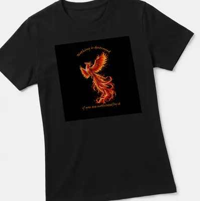 Vibrant Phoenix graphic with motivational text in fiery colors — printed on a women's shirt