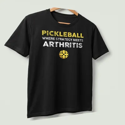 Bold and playful Pickleball humor shirt with yellow, white, and brown text — printed on a unisex t-shirt (angled view)