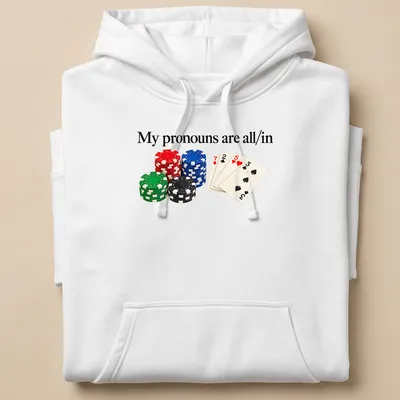 Graphic tee featuring poker chips and playing cards with bold text about pronouns — printed on a unisex hoodie