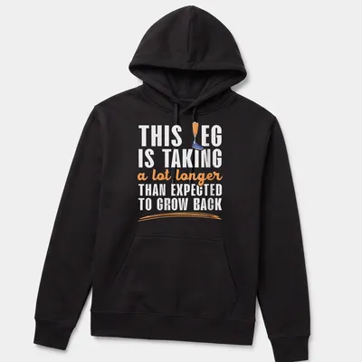 Playful cartoon t-shirt featuring a prosthetic leg humorously remarking on recovery time — printed on a unisex hoodie