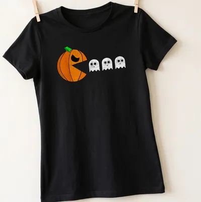 Cartoon design featuring playful pumpkins and ghosts for Halloween. — printed on a women's shirt