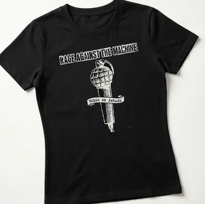 Vintage-style T-shirt featuring Rage Against The Machine text and a grenade-microphone design. — printed on a women's shirt
