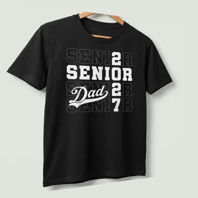 Bold typography Senior Dad shirt with graduation year 2027 — printed on a unisex t-shirt (angled view)