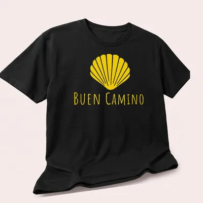 Minimalist design featuring a shell and the words Buen Camino in yellow — printed on a unisex t-shirt (angled view)