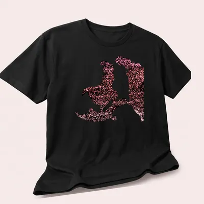 Glittering silhouette design with characters and text 'A Whole New World' — printed on a unisex t-shirt (angled view)