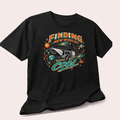Vintage retro shirt featuring a space telescope and colorful text about finding new worlds — printed on a unisex t-shirt (angled view)