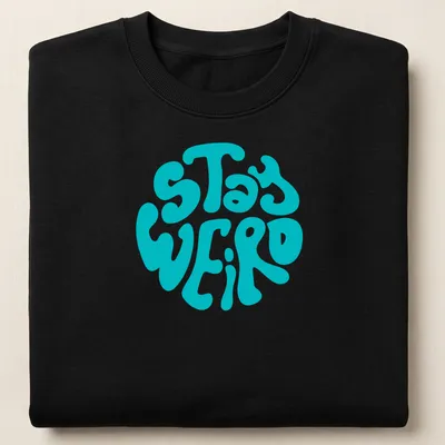 Round design t-shirt with bold 'Stay Weird' text in playful typography — printed on a unisex sweatshirt