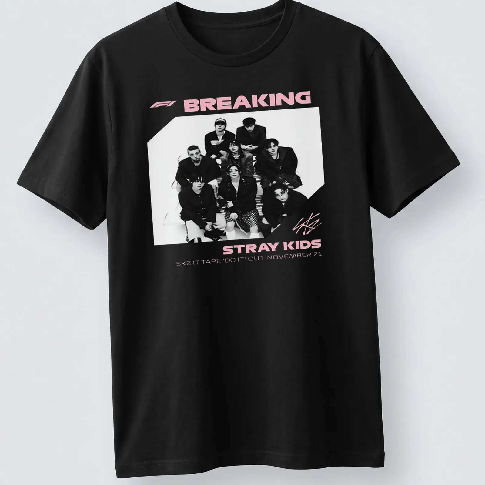 Monochrome shirt featuring Stray Kids graphic and text in black, white, and pink — printed on a unisex t-shirt