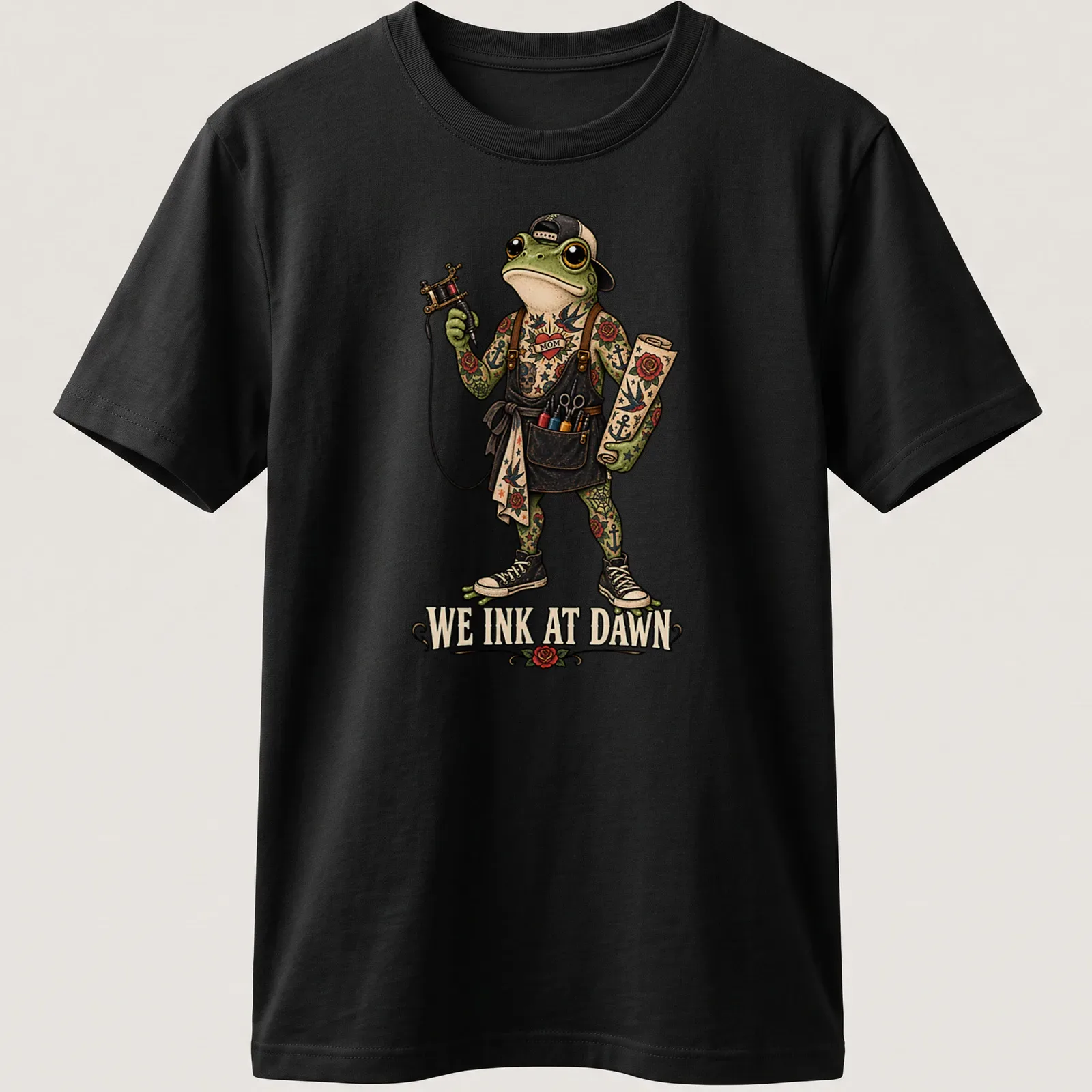 Vintage tattoo style t-shirt featuring a frog with the text We Ink At Dawn. — printed on a unisex t-shirt