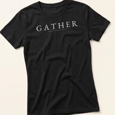 Minimalist Thanksgiving t-shirt with the word GATHER in white typography — printed on a women's shirt
