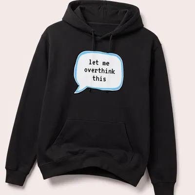 Cartoon thought bubble with the text 'let me overthink this' in light blue and black — printed on a unisex hoodie