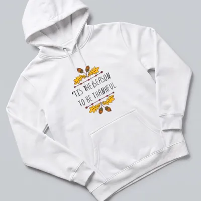 Hand-drawn illustration of autumn leaves and acorns with text 'TIS THE SEASON TO BE THANKFUL' — printed on a unisex hoodie