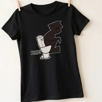 Cartoon little guy sitting on a toilet with the word 'PLOP!' above him — printed on a women's shirt