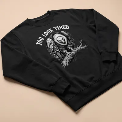 Vulture graphic with the text 'YOU LOOK TIRED' in retro font — printed on a unisex sweatshirt