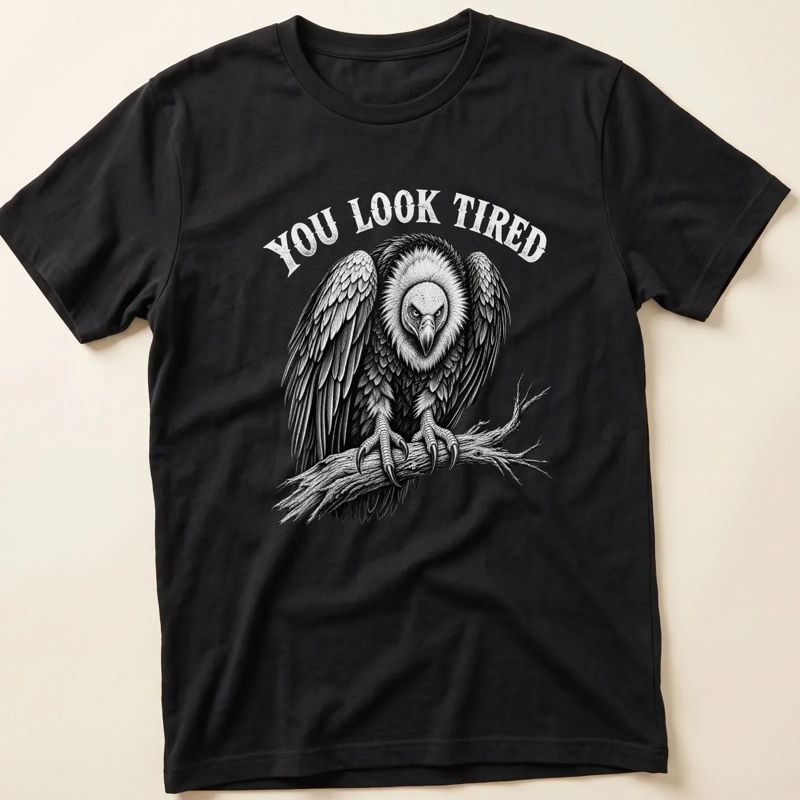 Vulture graphic with the text 'YOU LOOK TIRED' in retro font — printed on a unisex t-shirt