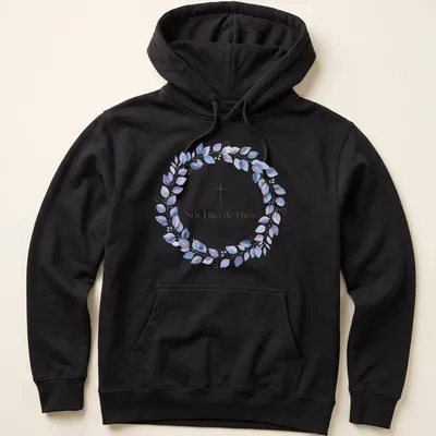 Watercolor design featuring cross and leaves with text 'Soy Hijo de Dios' in purple, blue, green, and white — printed on a unisex hoodie