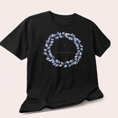 Watercolor design featuring cross and leaves with text 'Soy Hijo de Dios' in purple, blue, green, and white — printed on a unisex t-shirt (angled view)