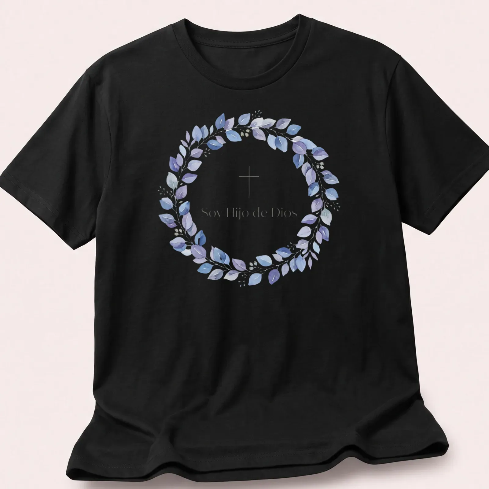 Watercolor design featuring cross and leaves with text 'Soy Hijo de Dios' in purple, blue, green, and white — printed on a unisex t-shirt