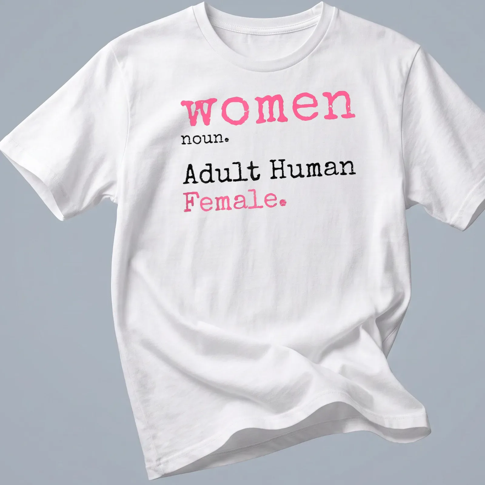 Playful typography t-shirt defining 'women noun. Adult Human Female.' in pink, black, and white. — printed on a unisex t-shirt
