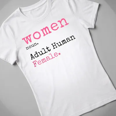 Playful typography t-shirt defining 'women noun. Adult Human Female.' in pink, black, and white. — printed on a women's shirt